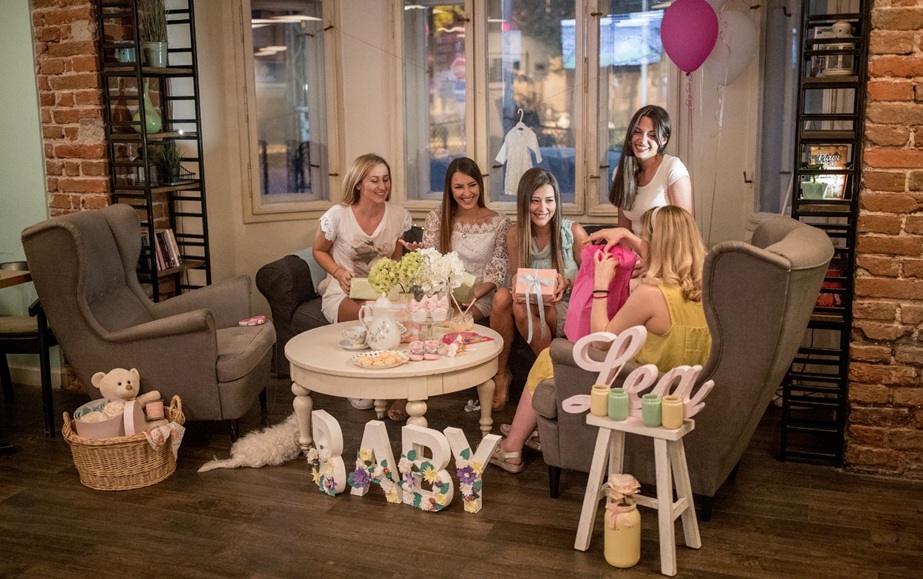 - Women gathered around coffee table as guest opens pink gift bag with balloons and floral BABY letters. - Image Name: Pink Baby Shower Room Alt Text: Pink-themed baby shower setup with cake table, stuffed toys, gift boxes, crib, and decorative banner. - Image Name: Gender Reveal Display Alt Text: Two wicker bassinets with pink and blue accents, blocks spelling BOY OR GIRL in front. - Image Name: Outdoor Baby Shower Setup Alt Text: Pregnant woman seated outdoors with blue balloons, BABY blocks, OH BOY banner, and adventure balloon. - Image Name: Baby Shower Food Spread Alt Text: Appetizer table with mini sandwiches, tortilla roll-ups, avocado cups, and vegetable sticks with dip. Would you like me to refine these into a consistent naming convention (e.g., “BabyShower_01,” “BabyShower_02”) for easier organization? 