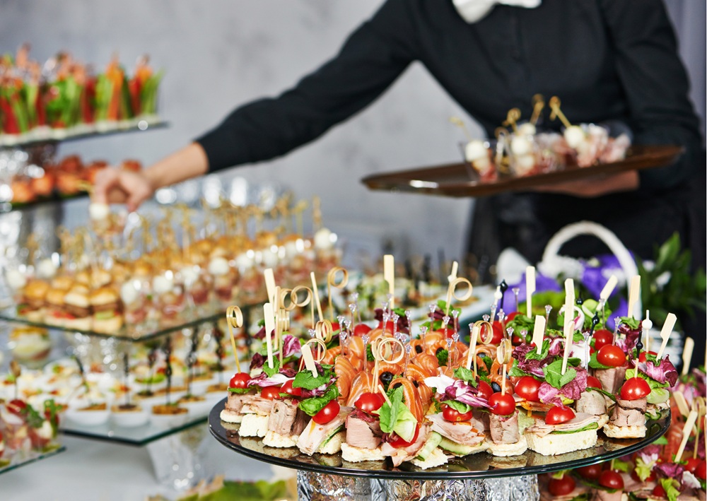 Professional catering service with gourmet appetizers and hors d'oeuvres arranged on serving platters.