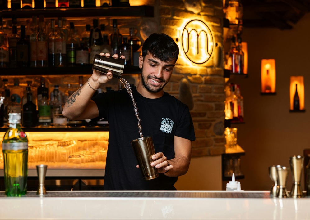 Bartender prepares a creative drink performance, offering sophisticated Bar Mitzvah entertainment for older guests.