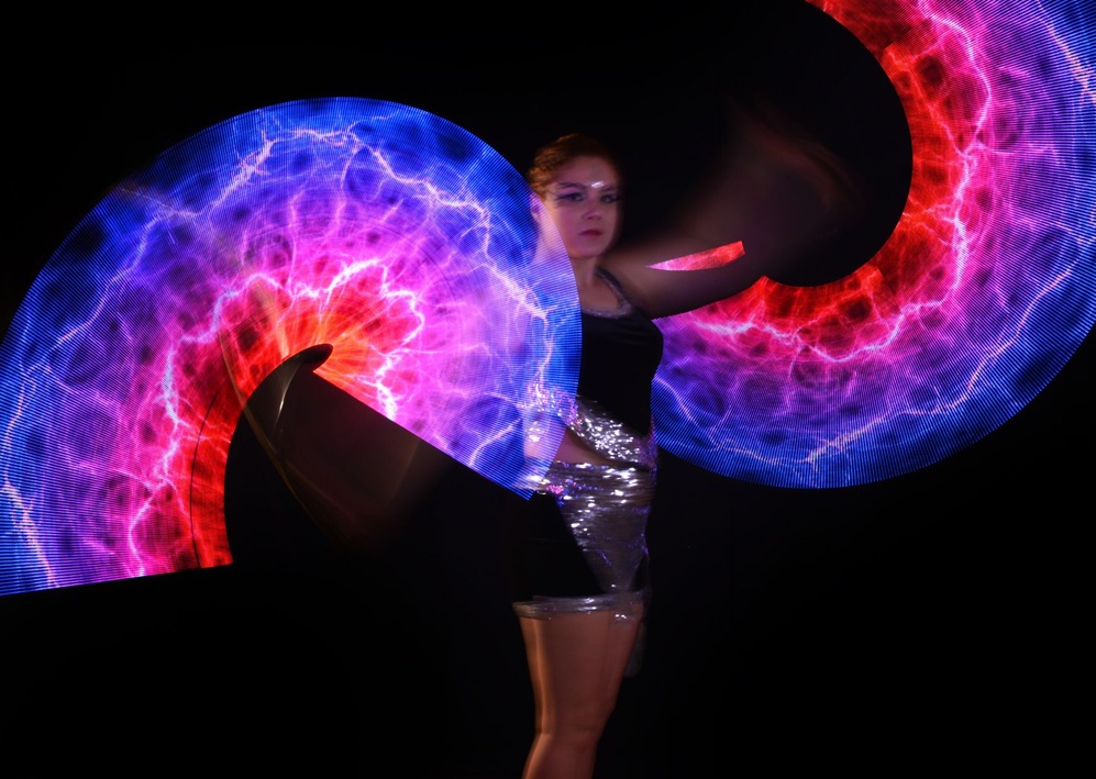 Performer creates glowing visual effects onstage, presenting a dramatic Bar Mitzvah entertainment experience.