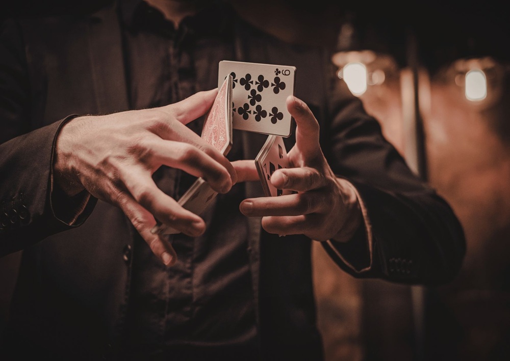 Magician performs a card trick, offering interactive entertainment ideas for an unforgettable Bar Mitzvah party.